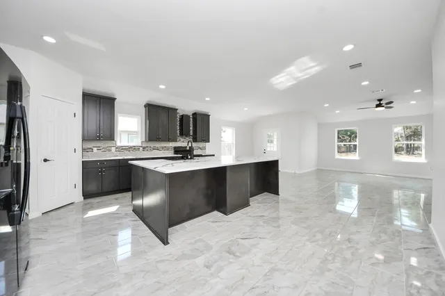 a kitchen with a sink appliances and cabinets