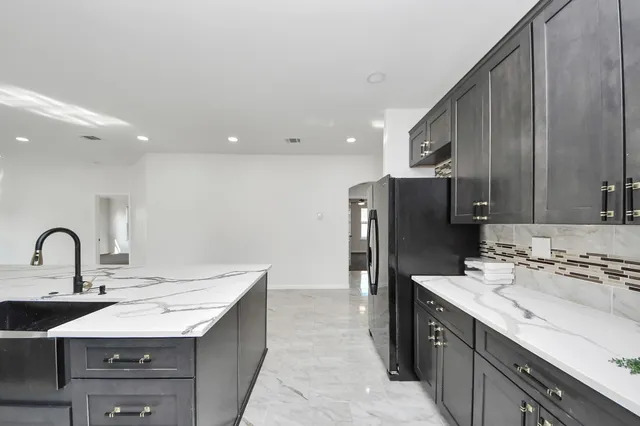 a kitchen with a sink and cabinets