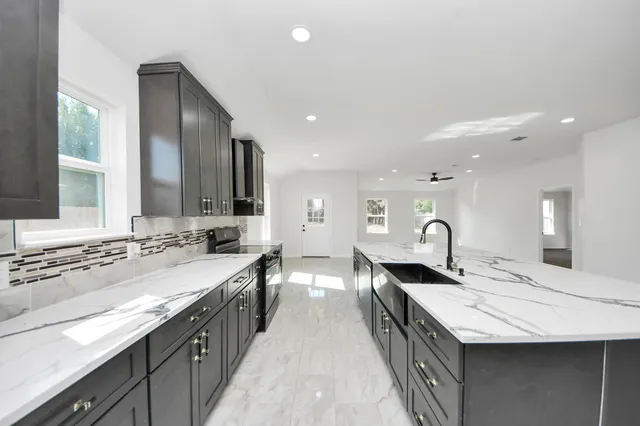 a kitchen with a sink stove and refrigerator