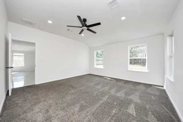 wooden floor in an empty room and a bathroom