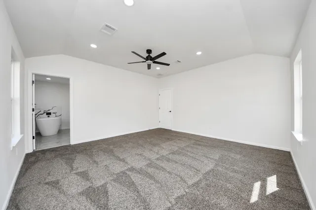 a view of a livingroom with a ceiling fan and window