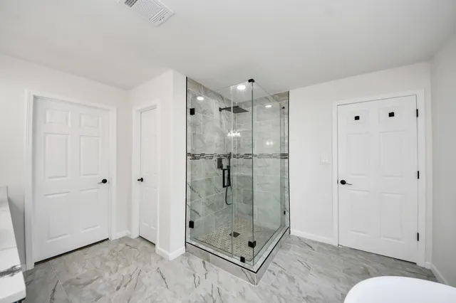 a view of a house with a yard and fence