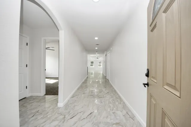 a view of a hallway with wooden shelves
