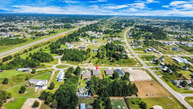 a view of a yard in front of a house with a large tree