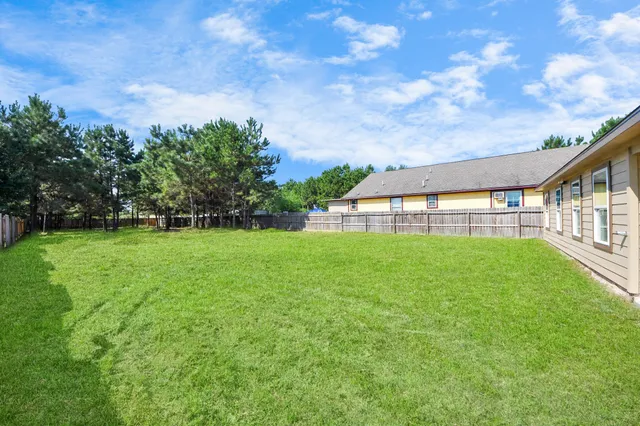 a green field with lots of trees