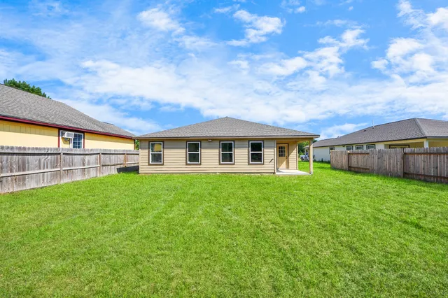 aerial view of a house with fountain and large trees