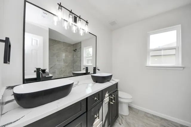 an empty room with a window and a ceiling fan