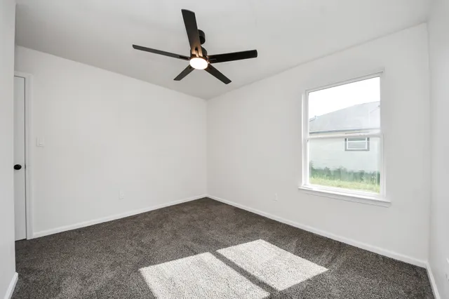 a bathroom with a bathtub shower sink mirror vanity and toilet