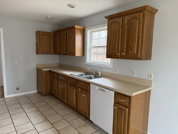 a kitchen with a sink cabinets and window