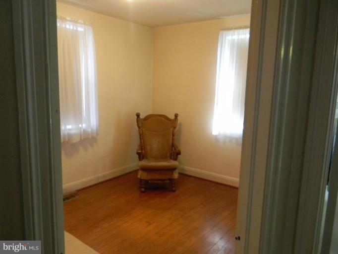226 Pinewood Road Dundalk, MD 21222 - Photo 7 of 12 a room with a chair and windows