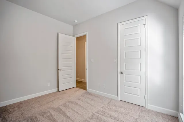 an empty room with closet area