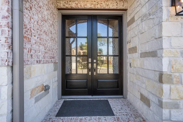 a bathroom with a glass door shower and a sink