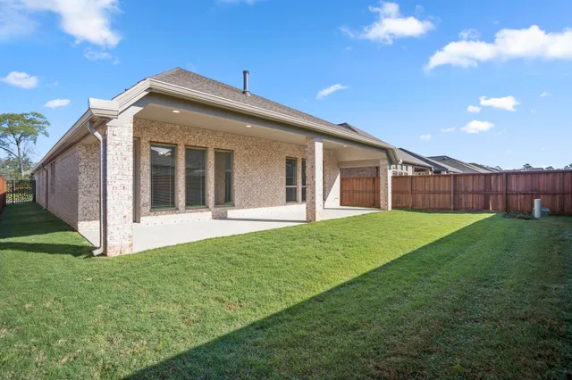 a view of an house with backyard and porch