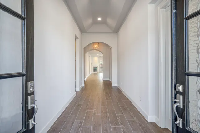 a view of a hallway view with wooden floor and staircase