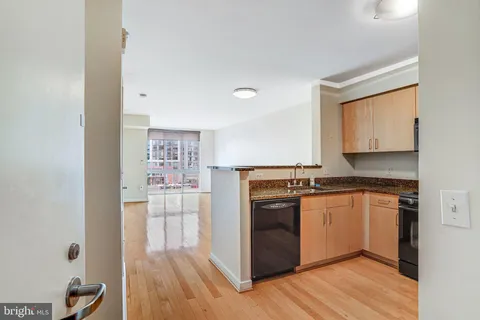a kitchen with stainless steel appliances granite countertop a stove and a refrigerator
