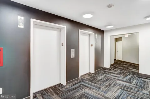 a bedroom with a bed and a mirror