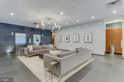 a living room with furniture and a chandelier