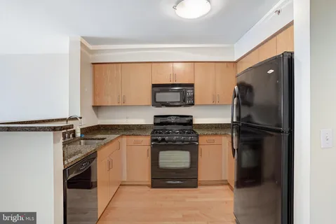 a kitchen with a refrigerator stove and microwave