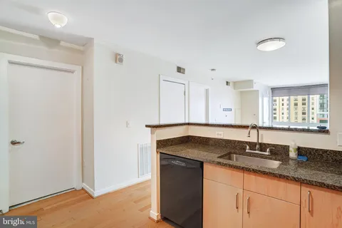 a kitchen with granite countertop a sink and a window