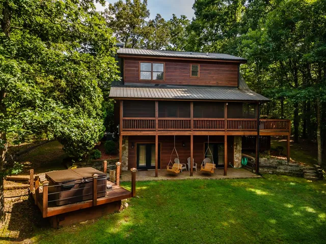 a view of a house with a backyard