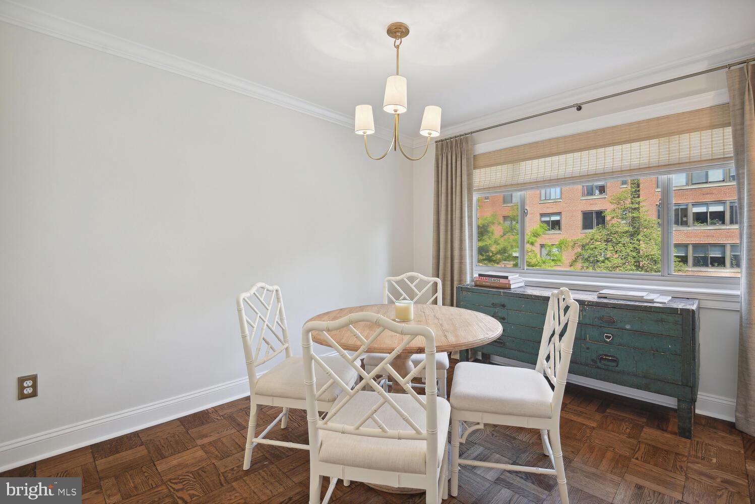 3900 Tunlaw Road Northwest, Unit 406 Washington, DC 20007 - Photo 11 of 23 a dining room with furniture a chandelier and window