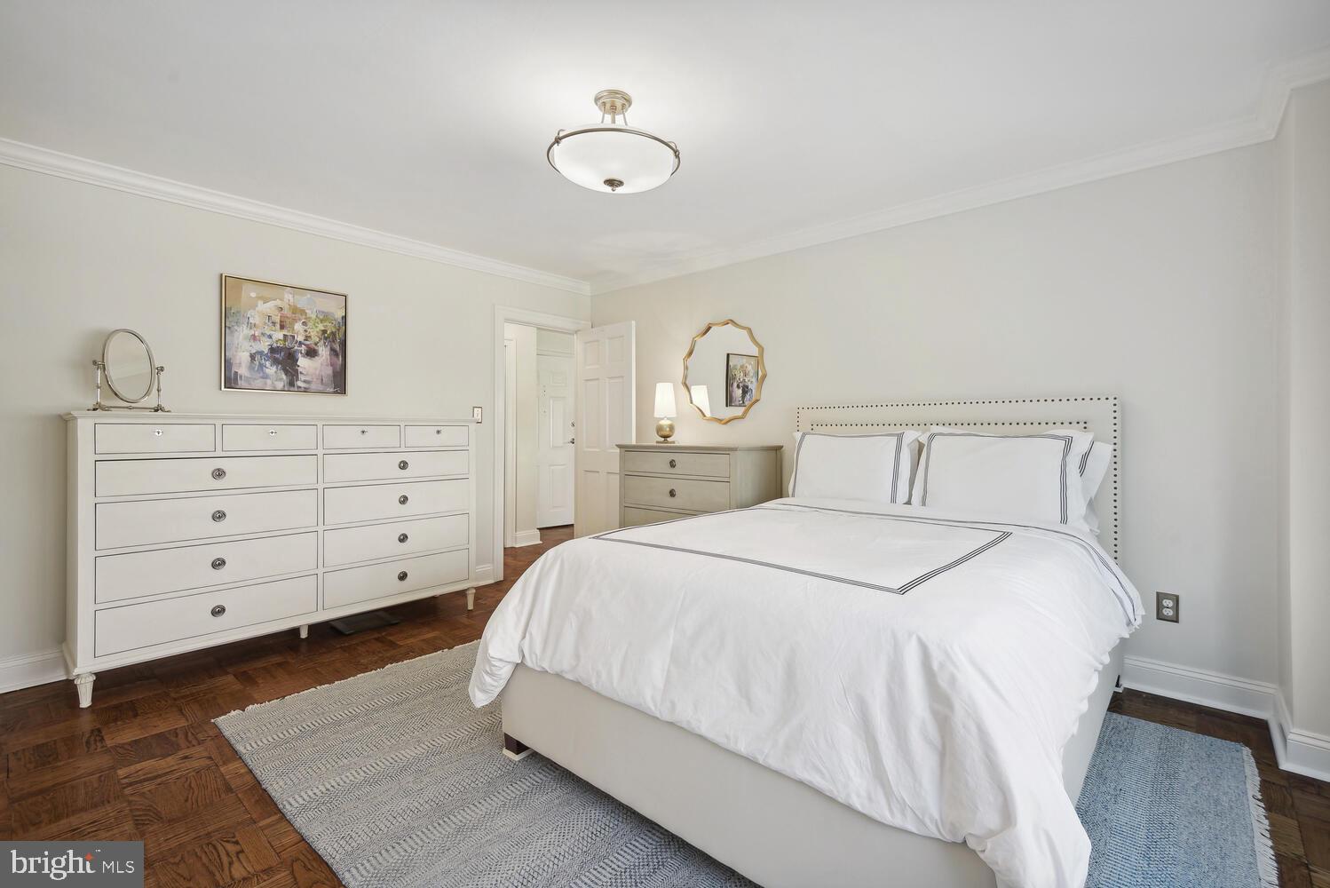 3900 Tunlaw Road Northwest, Unit 406 Washington, DC 20007 - Photo 13 of 23 a bedroom with a bed and a window