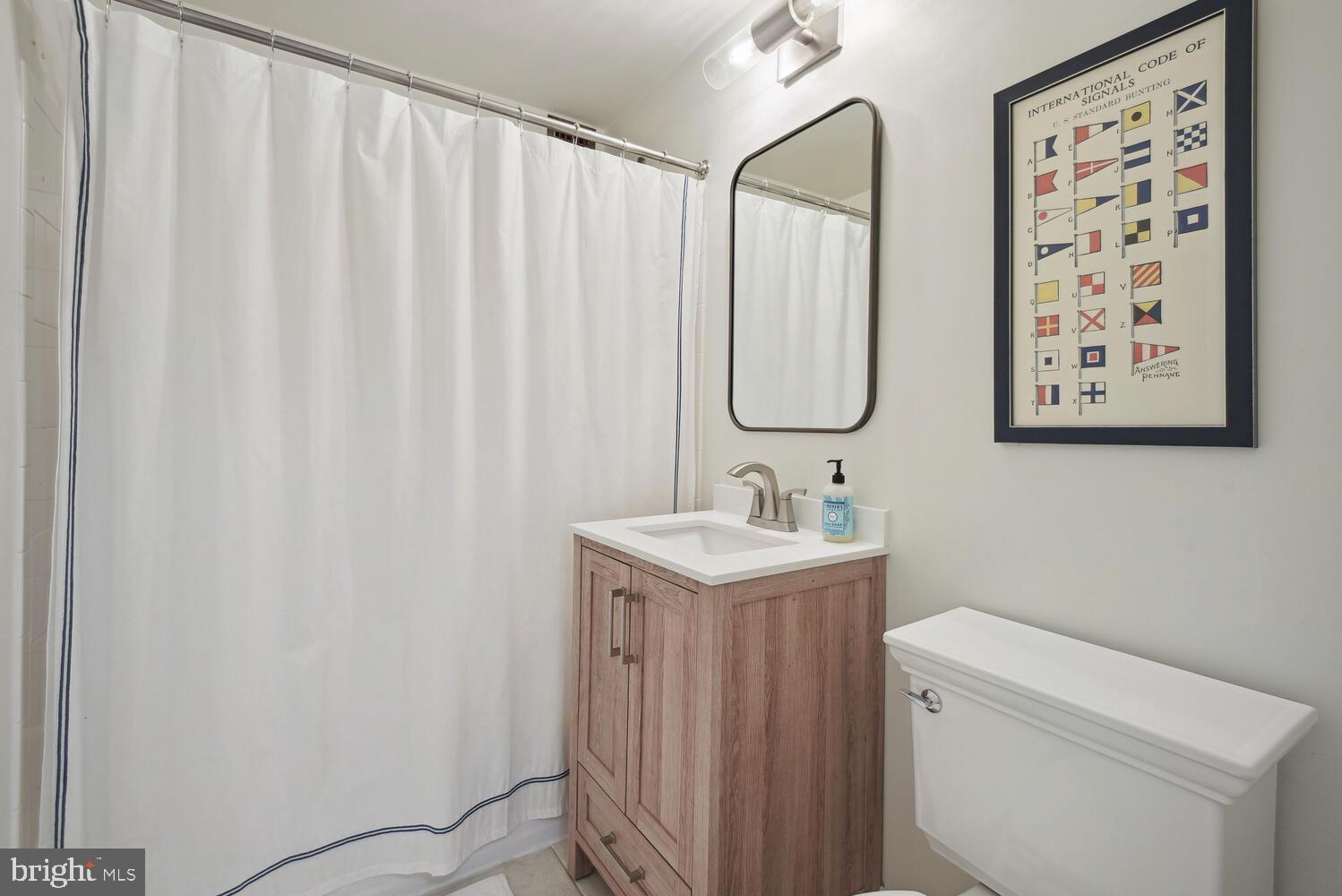 3900 Tunlaw Road Northwest, Unit 406 Washington, DC 20007 - Photo 16 of 23 a bathroom with a sink and a mirror