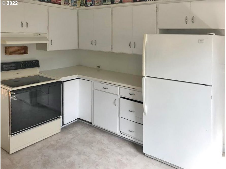 1891 Harris Street Eugene, OR 97403 - Photo 6 of 10 a white refrigerator freezer sitting in a kitchen