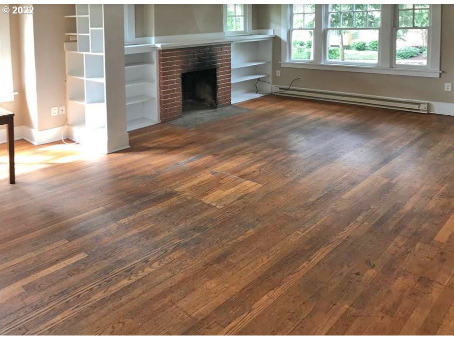 1891 Harris Street Eugene, OR 97403 - Photo 10 of 10 an empty room with wooden floor fireplace and windows