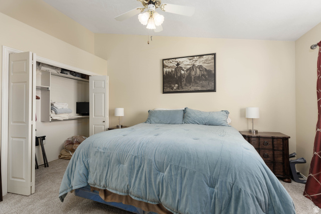 161 West 950 South, Unit S4 St. George, UT 84770 - Photo 16 of 21 Bedroom featuring light colored carpet, a closet, a ceiling fan, and lofted ceiling
