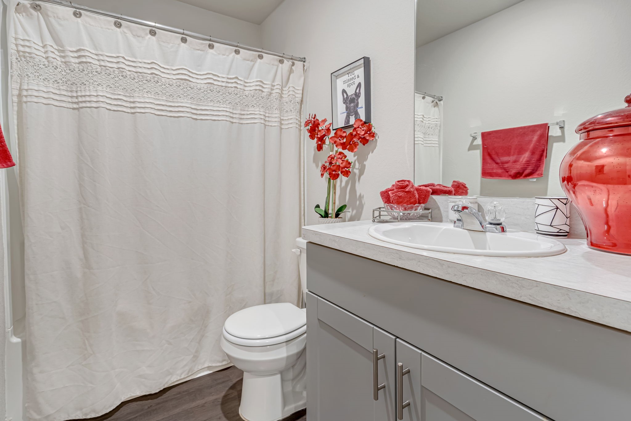 9921 Spring Creek Road Cleveland, TX 77327 - Photo 11 of 30 a bathroom with a sink a toilet and shower curtain