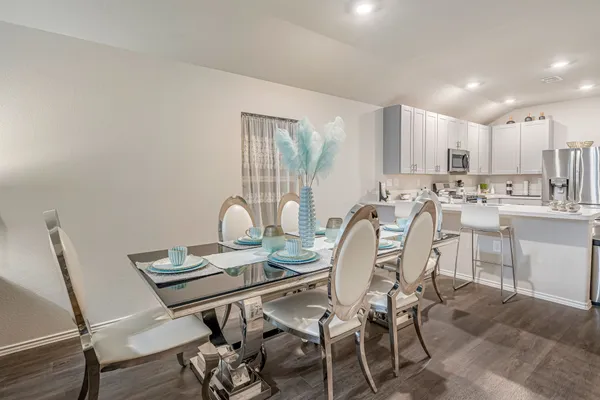a view of a dining room with furniture and a window