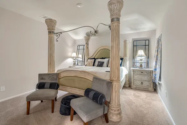 a bedroom with furniture and a chandelier