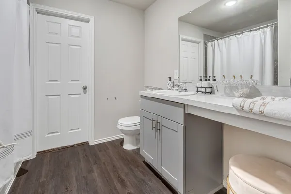 a bathroom with a toilet sink and mirror