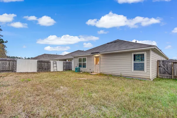 a view of a house with a backyard