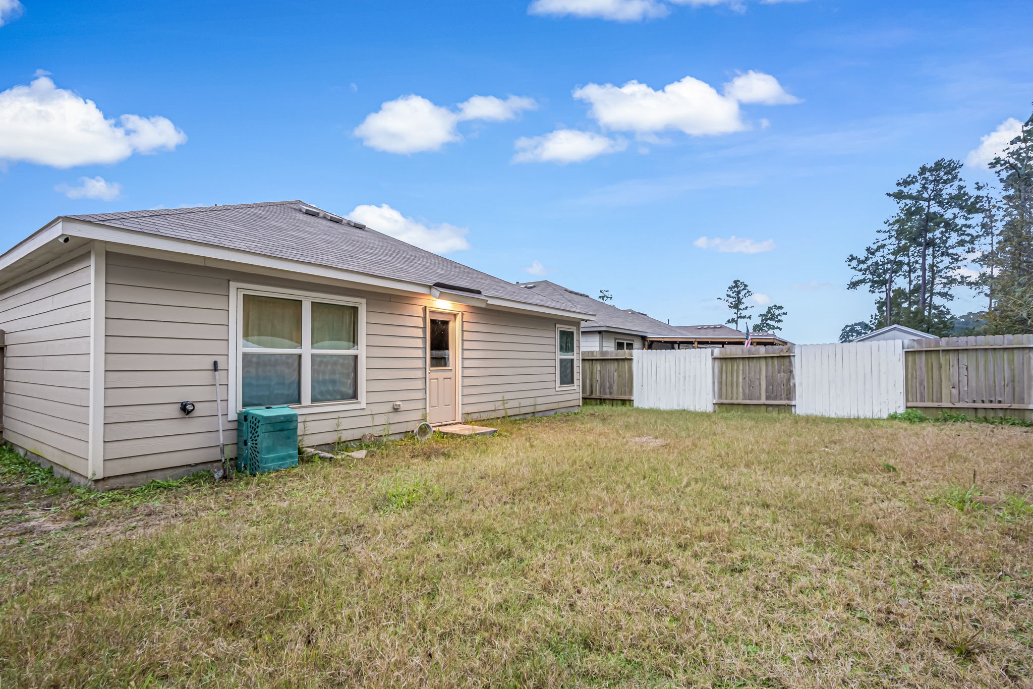 9921 Spring Creek Road Cleveland, TX 77327 - Photo 27 of 30 a view of a house with a backyard