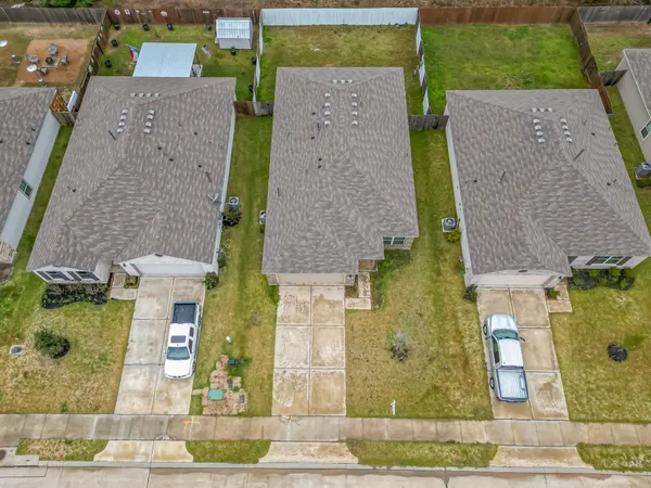 front view of a brick house with a yard