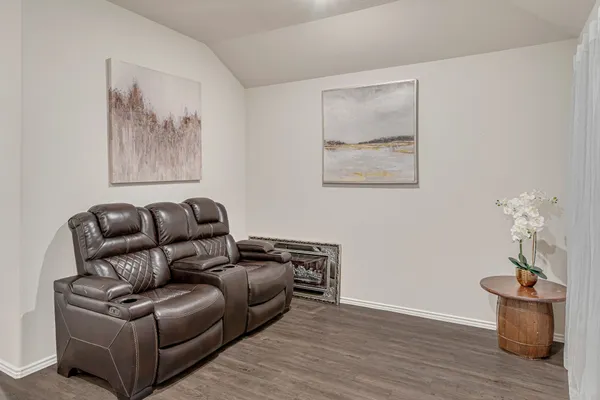 a living room with furniture and wooden floor