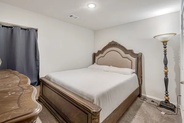 a bedroom with a bed and a table