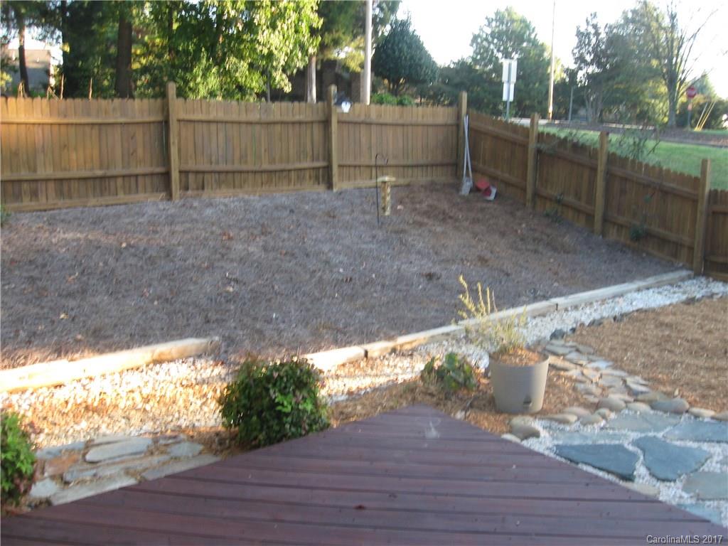 12515 Newstead Road Huntersville, NC 28078 - Photo 3 of 14 a view of a backyard with wooden fence