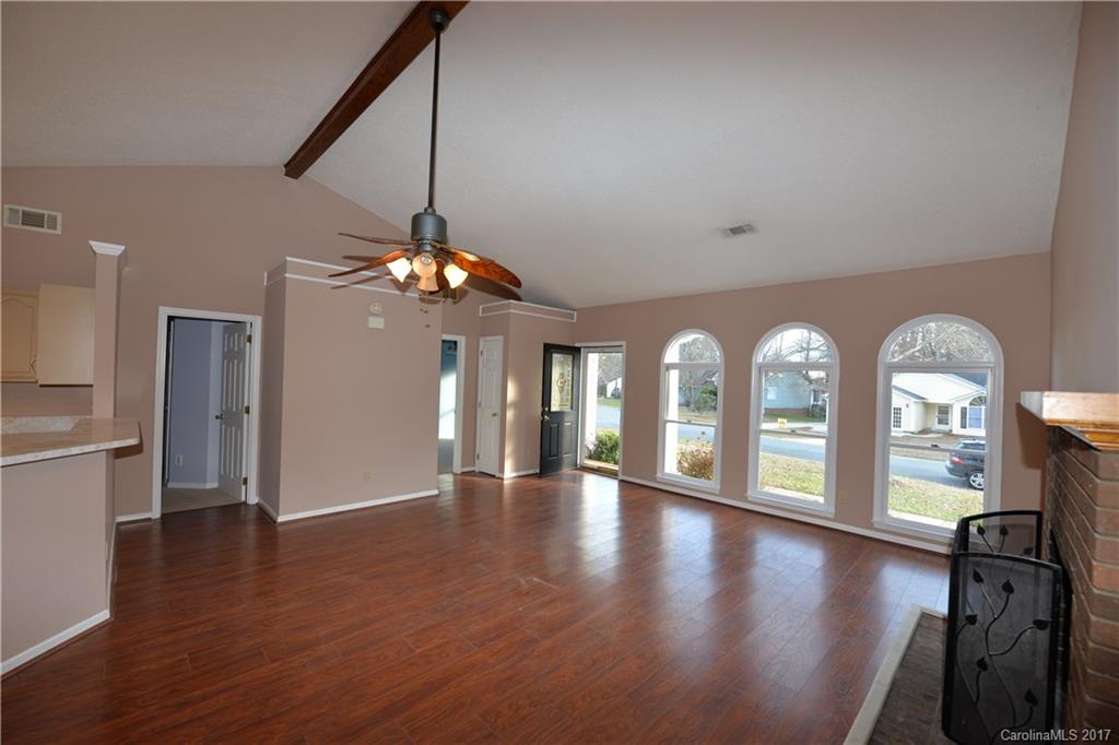12515 Newstead Road Huntersville, NC 28078 - Photo 7 of 14 a view of a room with lots of wooden floor and chandelier