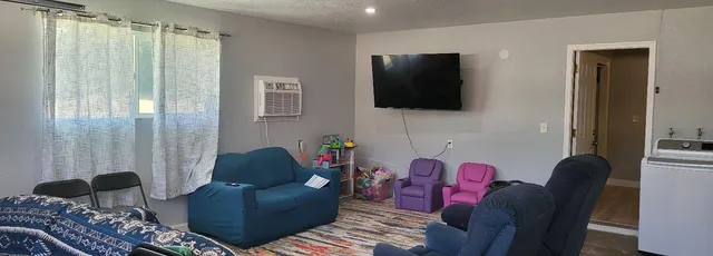 a living room with furniture and a flat screen tv