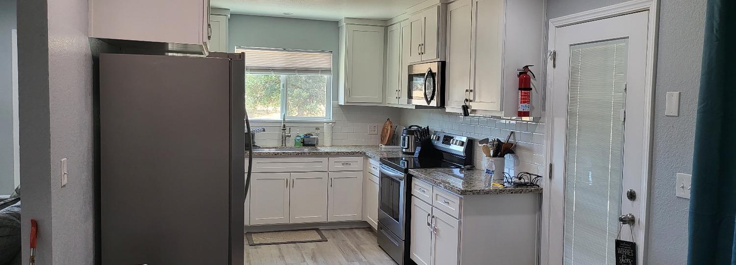 30530 George Smith Road Squaw Valley, CA 93675 - Photo 10 of 23 a kitchen with a refrigerator and window