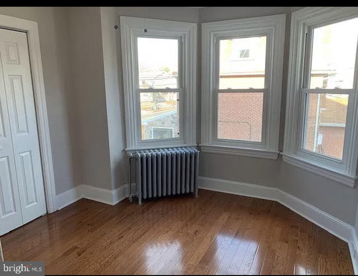 19 State Road Media, PA 19063 - Photo 11 of 18 an empty room with wooden floor and windows