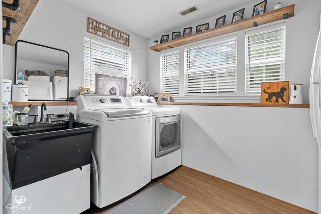 a view of a kitchen with a sink a window and stainless steel appliances