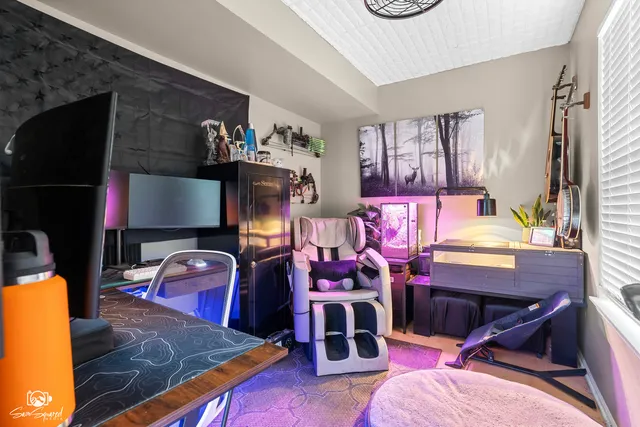 a living room with furniture a flat screen tv and a table