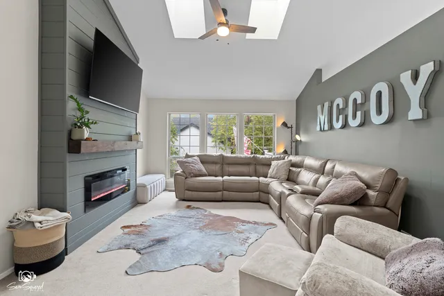 a living room with furniture a fireplace and a flat screen tv