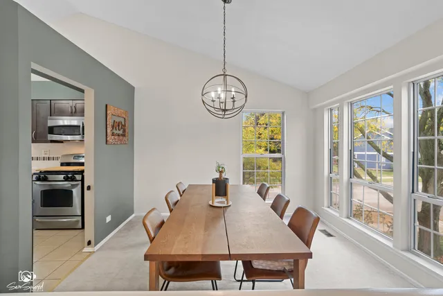 a view of a dining room with furniture large window and wooden floor