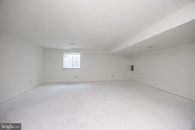 a large white kitchen with cabinets
