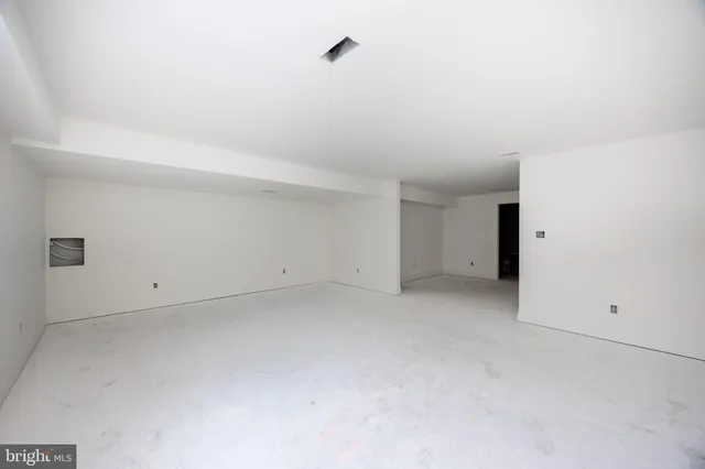 a large kitchen with cabinets and a refrigerator